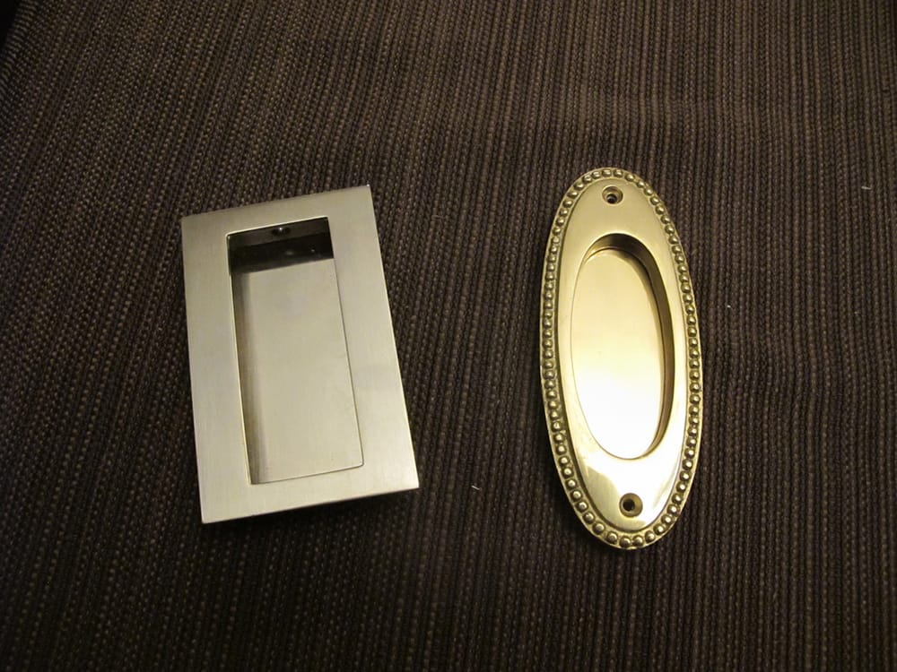 The homeowner wants different style pulls installed on opposite faces of a pocket door.