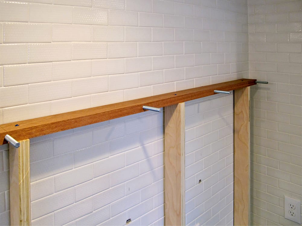 This alignment jig is used to drill the holes perpendicular to the wall, and into the studs in the wall.