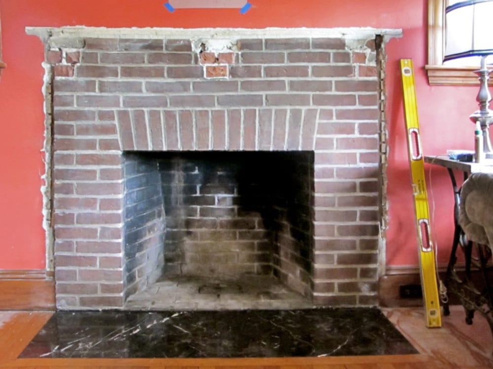 The brick fireplace with the corbels removed.