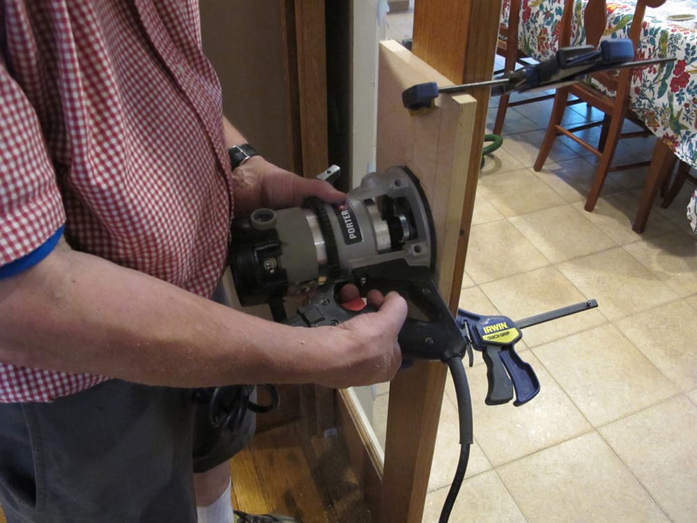 Jeff is using a router to cut the mortice for the rectangular pull.