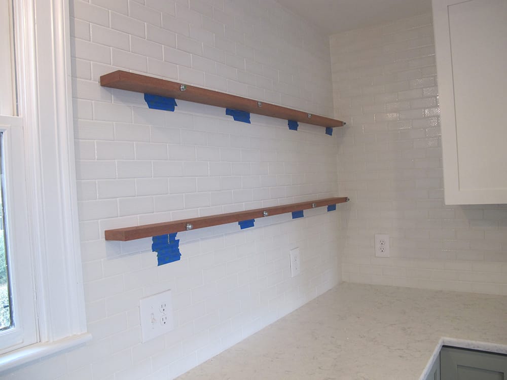 Four, 5/8” threaded rods, are mounted into the studs, using expanding polyurethane glue. The alignment jig is then bolted to the wall.