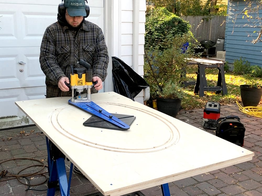 Using a router with an ellipse cutting jig to fabricate a rigid casing from baltic birch plywood.