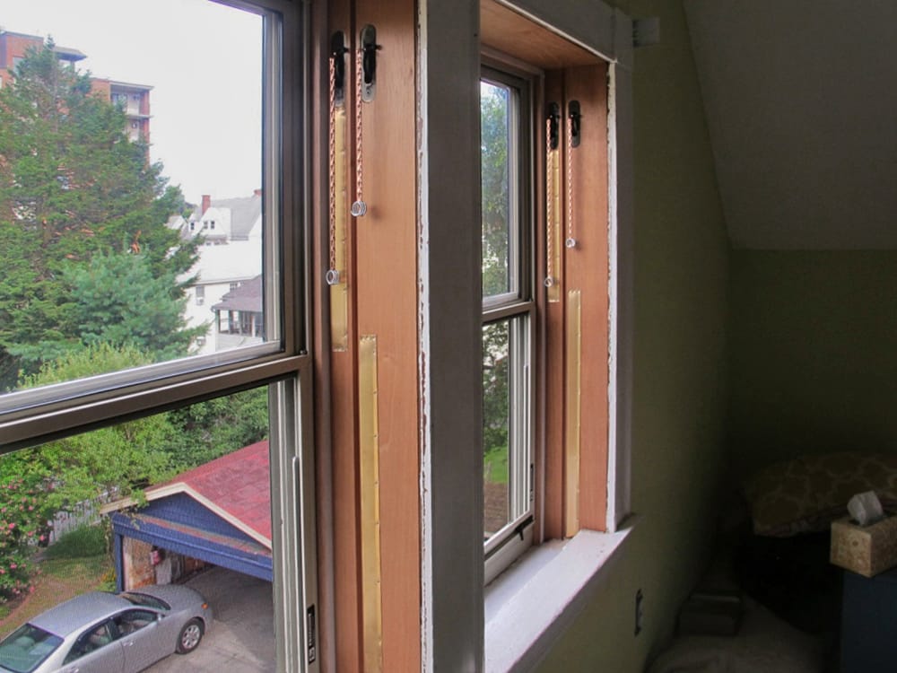 Storm windows and bronze weather stripping installed.