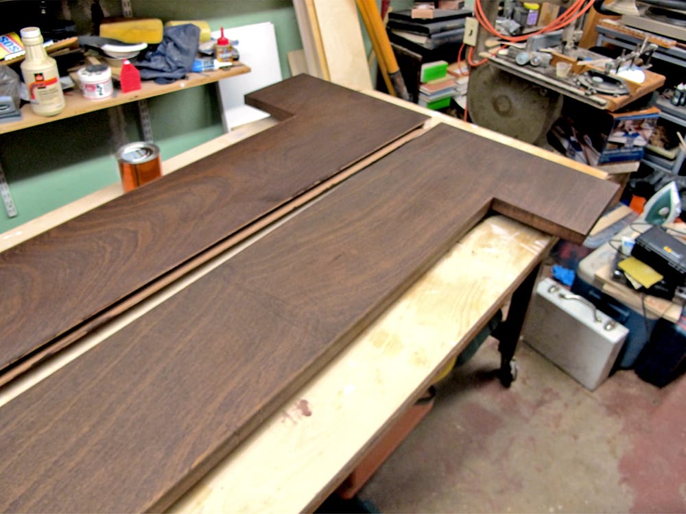 Shelves are stained, and ready to mount. The slots in the rear of the each shelf will be lathered with glue, and slid over the mounted jigs.