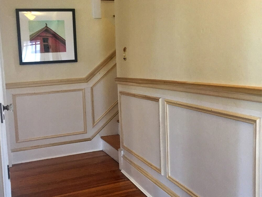 The hallway with the picture frame molding. We also installed a base cap on an otherwise plain baseboard.